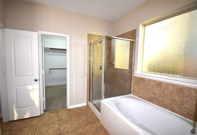 a bathroom with a bathtub and a shower