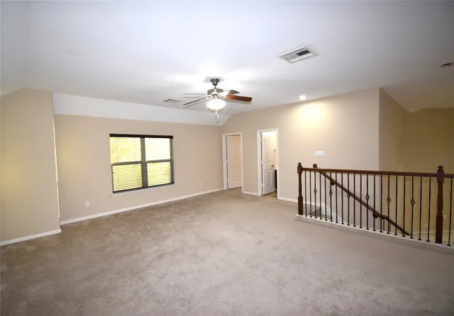 a view of a livingroom with a ceiling fan and window