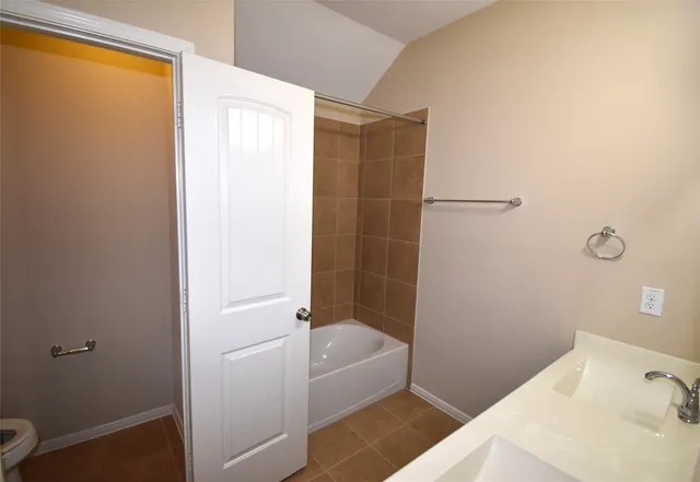 a bathroom with a bathtub and a sink