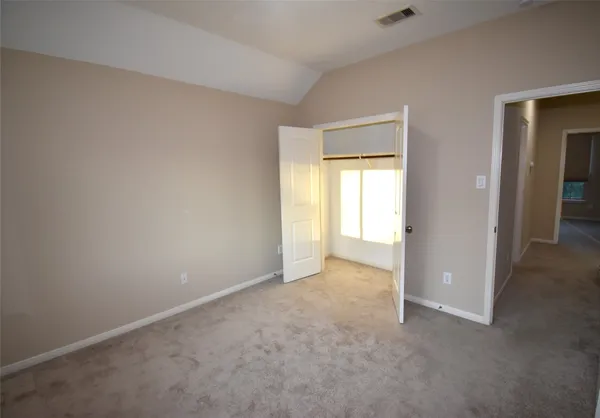 an empty room with windows and closet