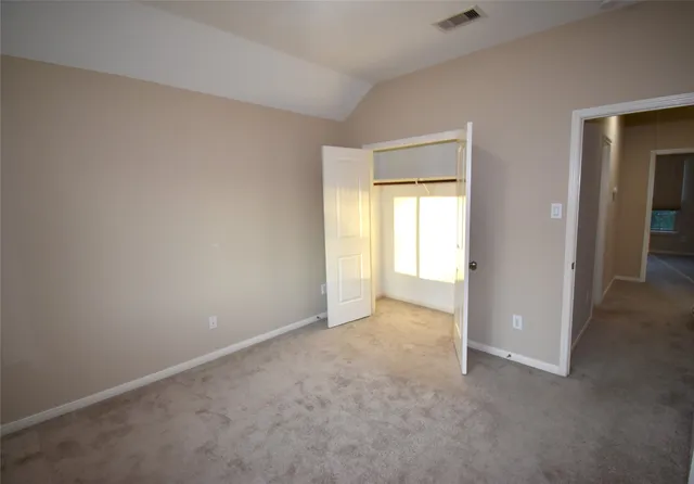 an empty room with windows and closet