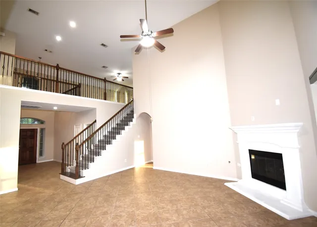 a view of entryway and hall with a fireplace