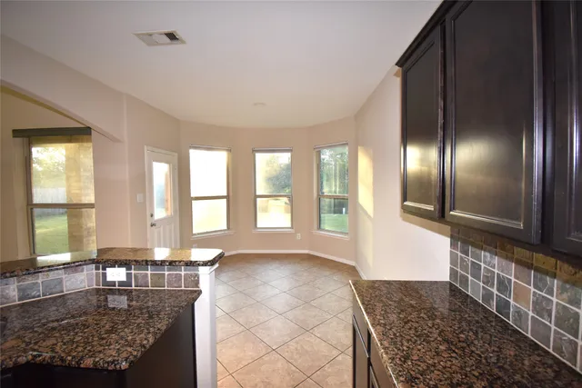 a large room with lots of windows and glass door