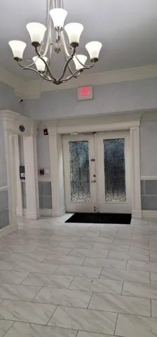 a living room with furniture a flat screen tv and kitchen view