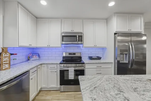 a view of a workspace with furniture and wooden floor