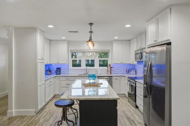 a bedroom with a large bed and a chandelier
