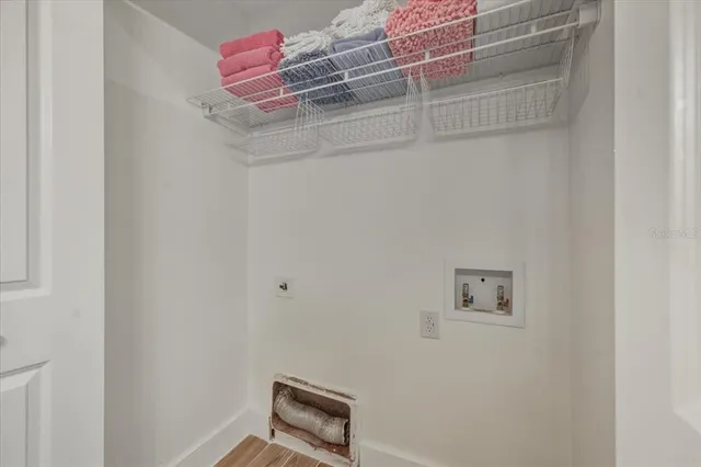 a view of a chairs and table in patio with a fireplace