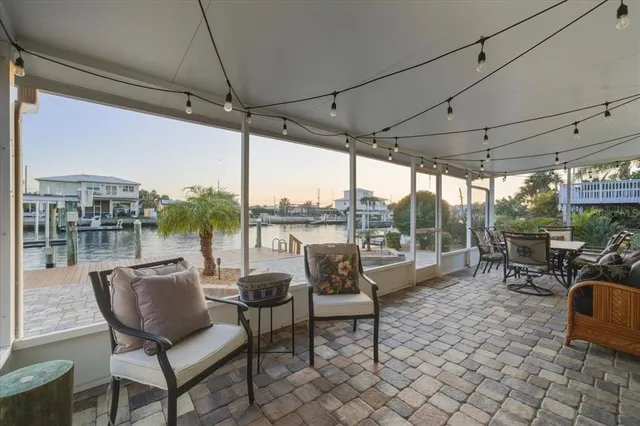 a view of a ocean with boats and trees in the background