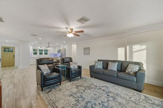 a kitchen with stainless steel appliances granite countertop a kitchen island a stove a table and chairs in it