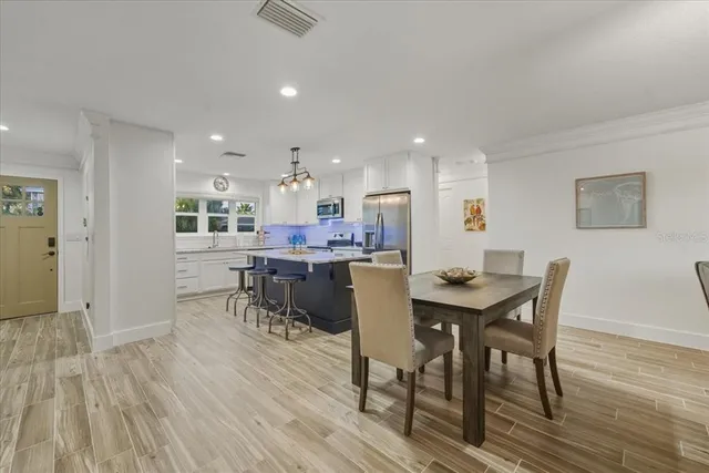 a kitchen with stainless steel appliances granite countertop a sink dishwasher and stove with wooden floor