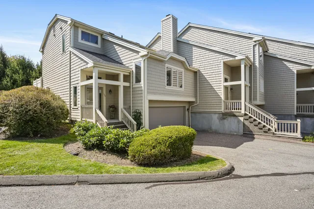 a view of a house with a small yard and plants