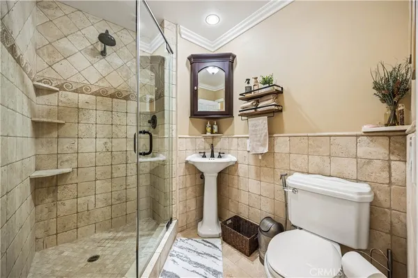 a bathroom with a toilet sink and shower