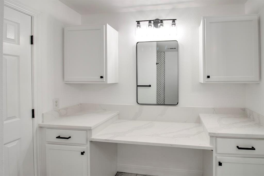 3884 Lois Road East Sanger, TX 76266 - Photo 23 of 40 a bathroom with a sink and cabinets