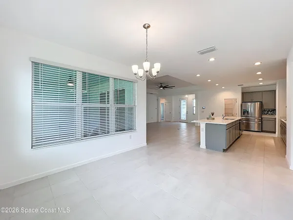 a view of a kitchen with a sink and a large window