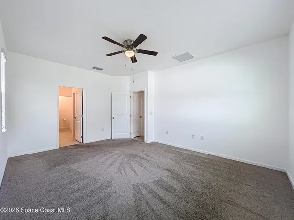 a view of a big room with wooden floor closet and windows