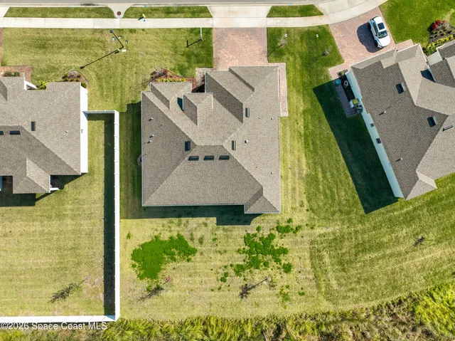 an aerial view of a house with a yard
