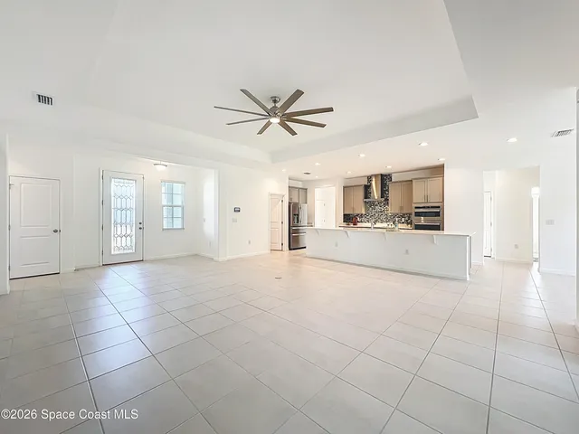 a view of a kitchen with an empty space and a sink cabinets