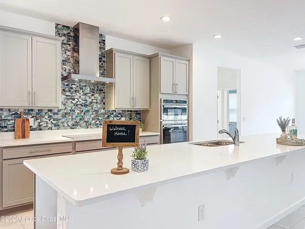 a kitchen with kitchen island a sink appliances and cabinets