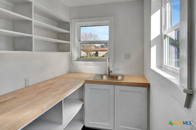 a hallway with a sink and a window