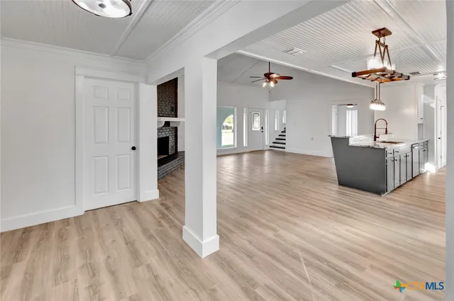 a view of a livingroom with wooden floor and staircase