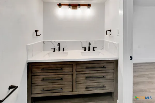 a bathroom with a sink vanity and a mirror