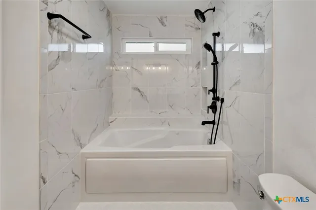 a bathroom with a bathtub and a shower