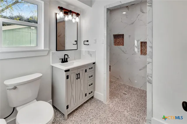 a bathroom with a toilet sink and mirror