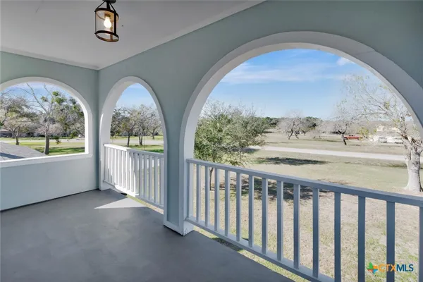 a view of balcony with wooden floor