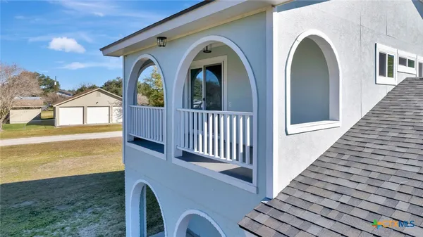 an aerial view of a house with a yard swimming pool and outdoor seating