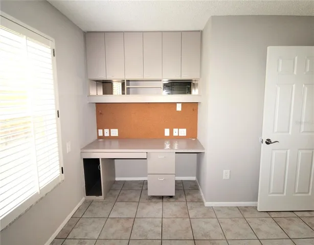 a view of backyard with wooden fence and a large tree