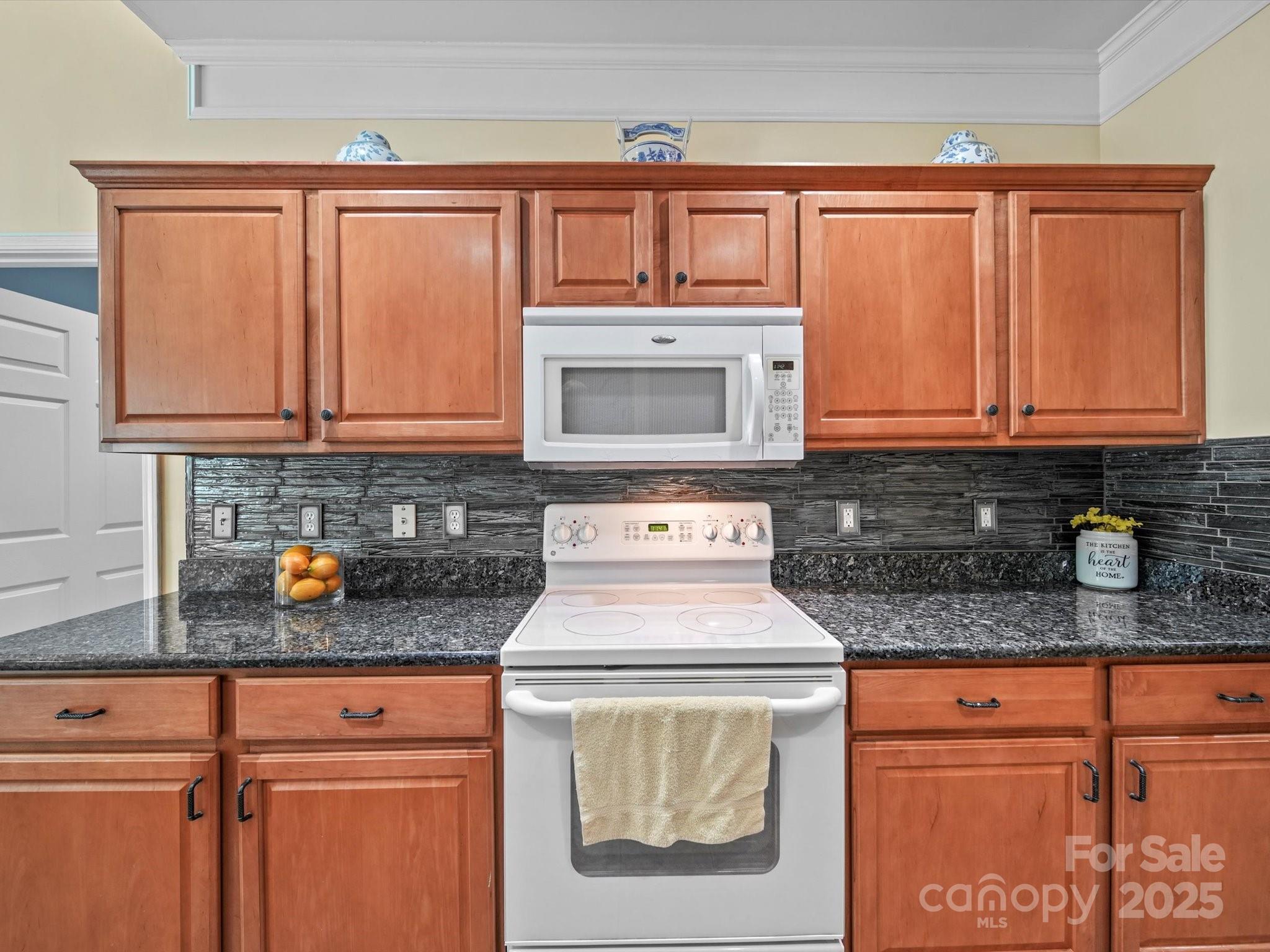 11761 Crossroads Place Concord, NC 28025 - Photo 14 of 32 a kitchen with stainless steel appliances granite countertop a sink stove and cabinets