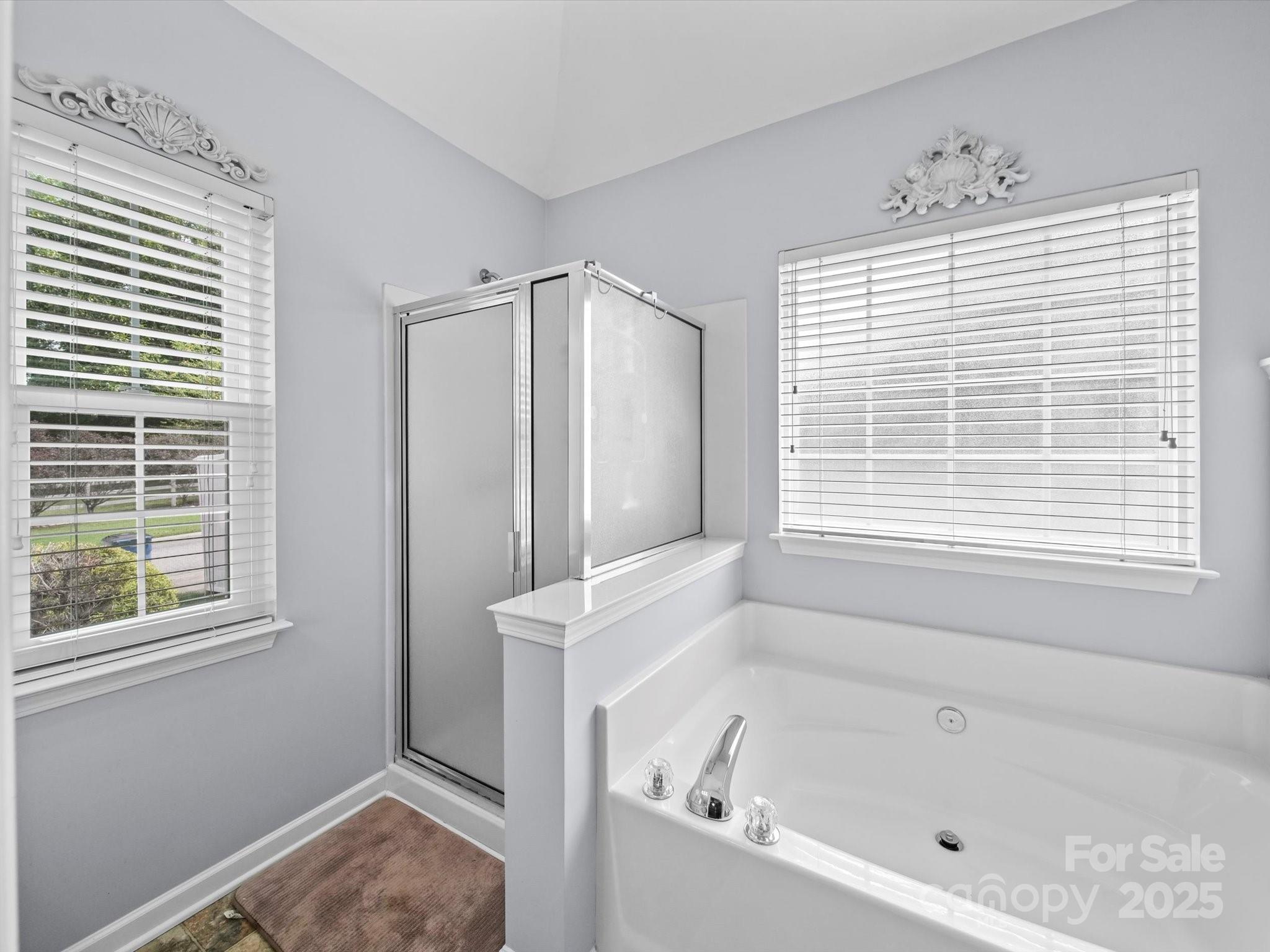 11761 Crossroads Place Concord, NC 28025 - Photo 23 of 32 a bathroom with a bathtub and a window