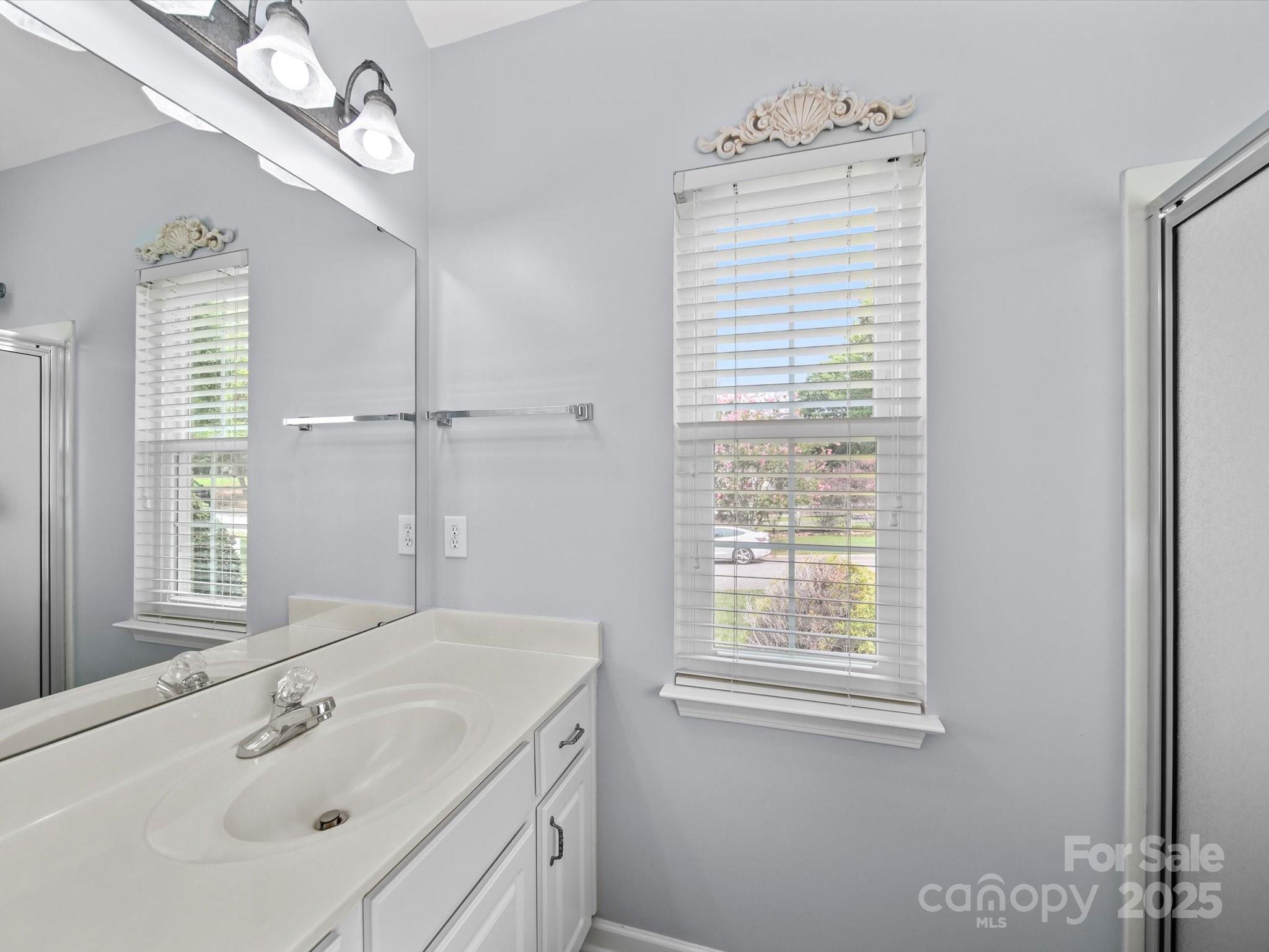11761 Crossroads Place Concord, NC 28025 - Photo 24 of 32 a bathroom with a sink a mirror and a window
