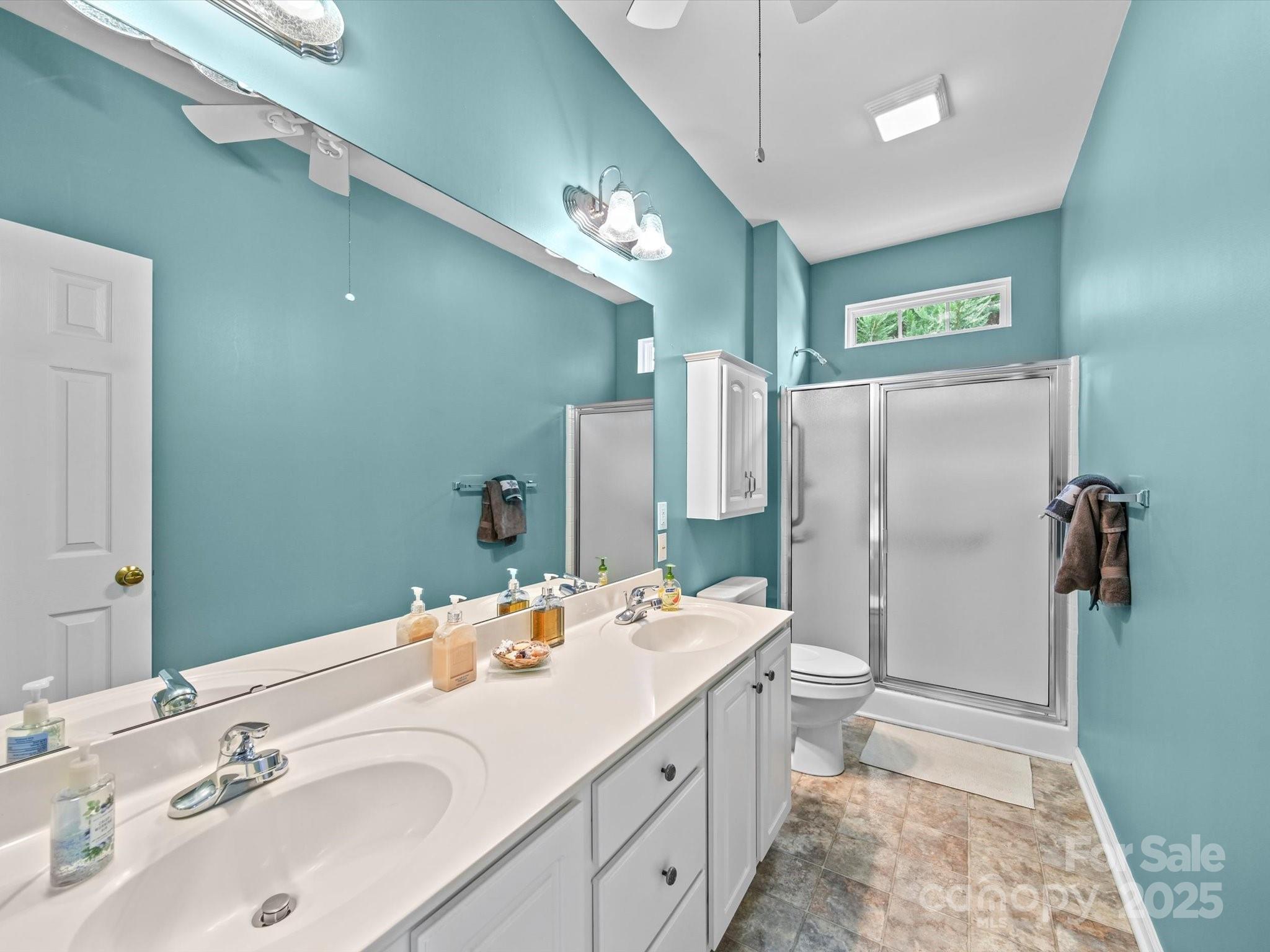 11761 Crossroads Place Concord, NC 28025 - Photo 27 of 32 a bathroom with a double vanity sink mirror and shower