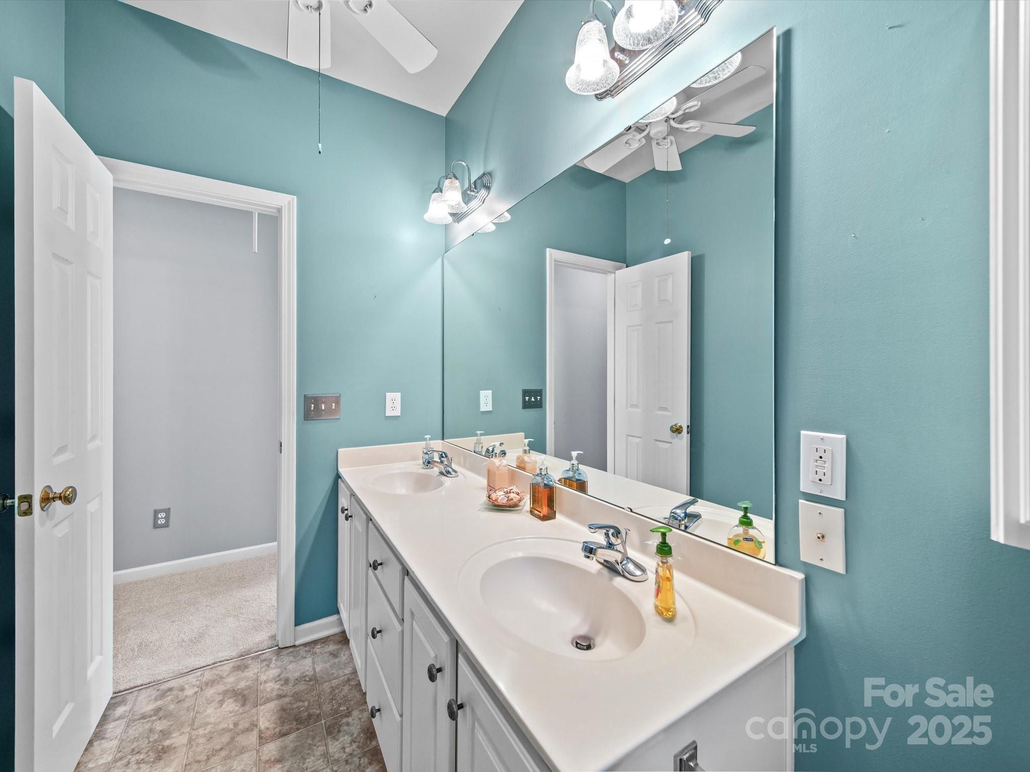 11761 Crossroads Place Concord, NC 28025 - Photo 28 of 32 a bathroom with a sink double vanity and a mirror
