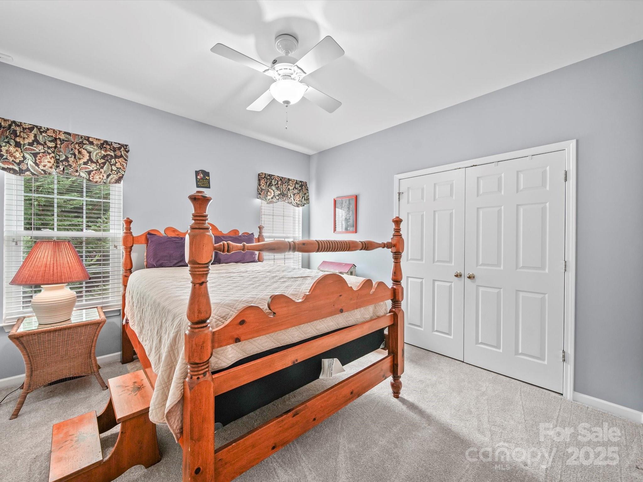 11761 Crossroads Place Concord, NC 28025 - Photo 29 of 32 a bed room with a bed and a chandelier