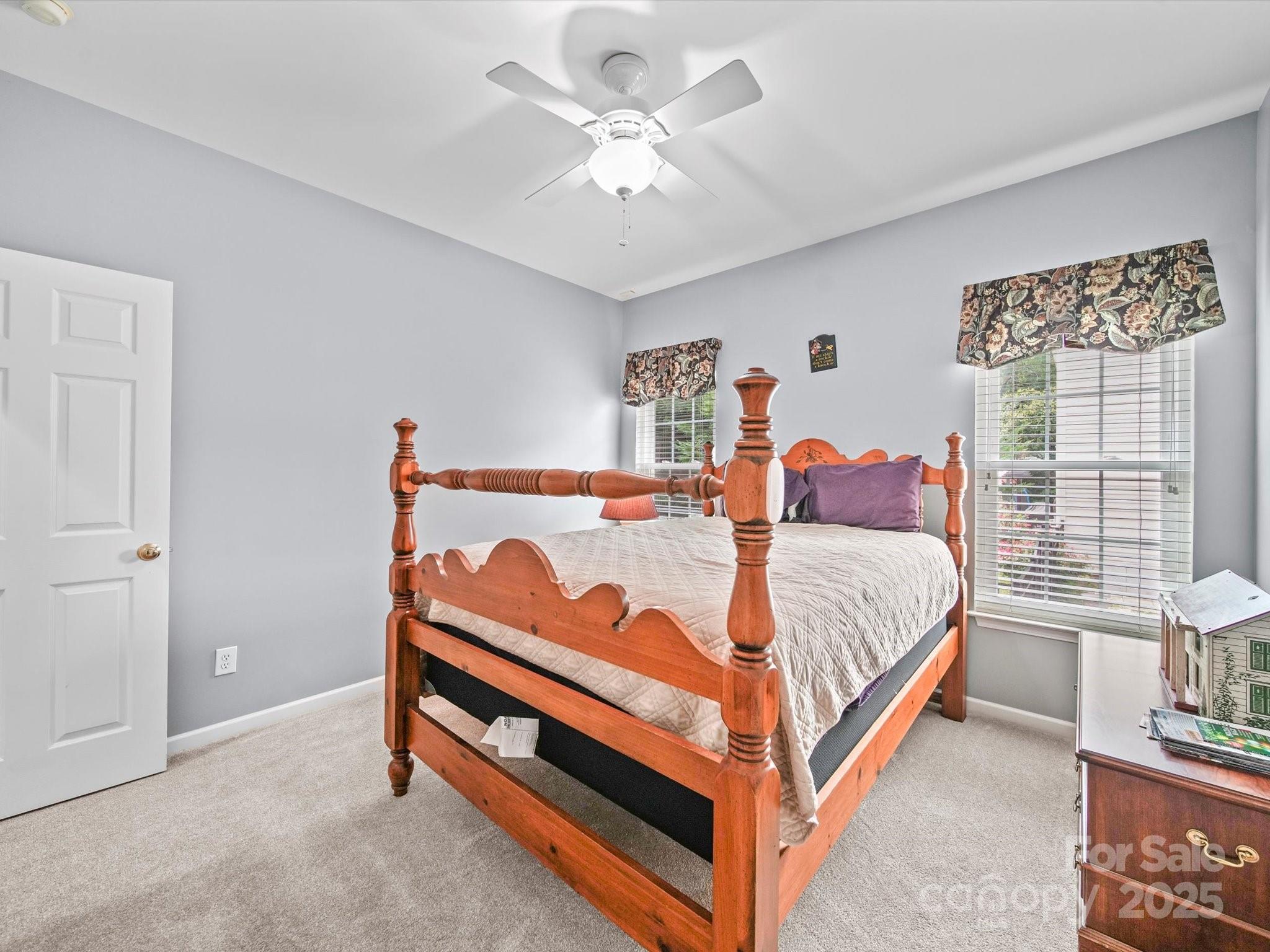 11761 Crossroads Place Concord, NC 28025 - Photo 30 of 32 a bedroom with a bed and a chandelier