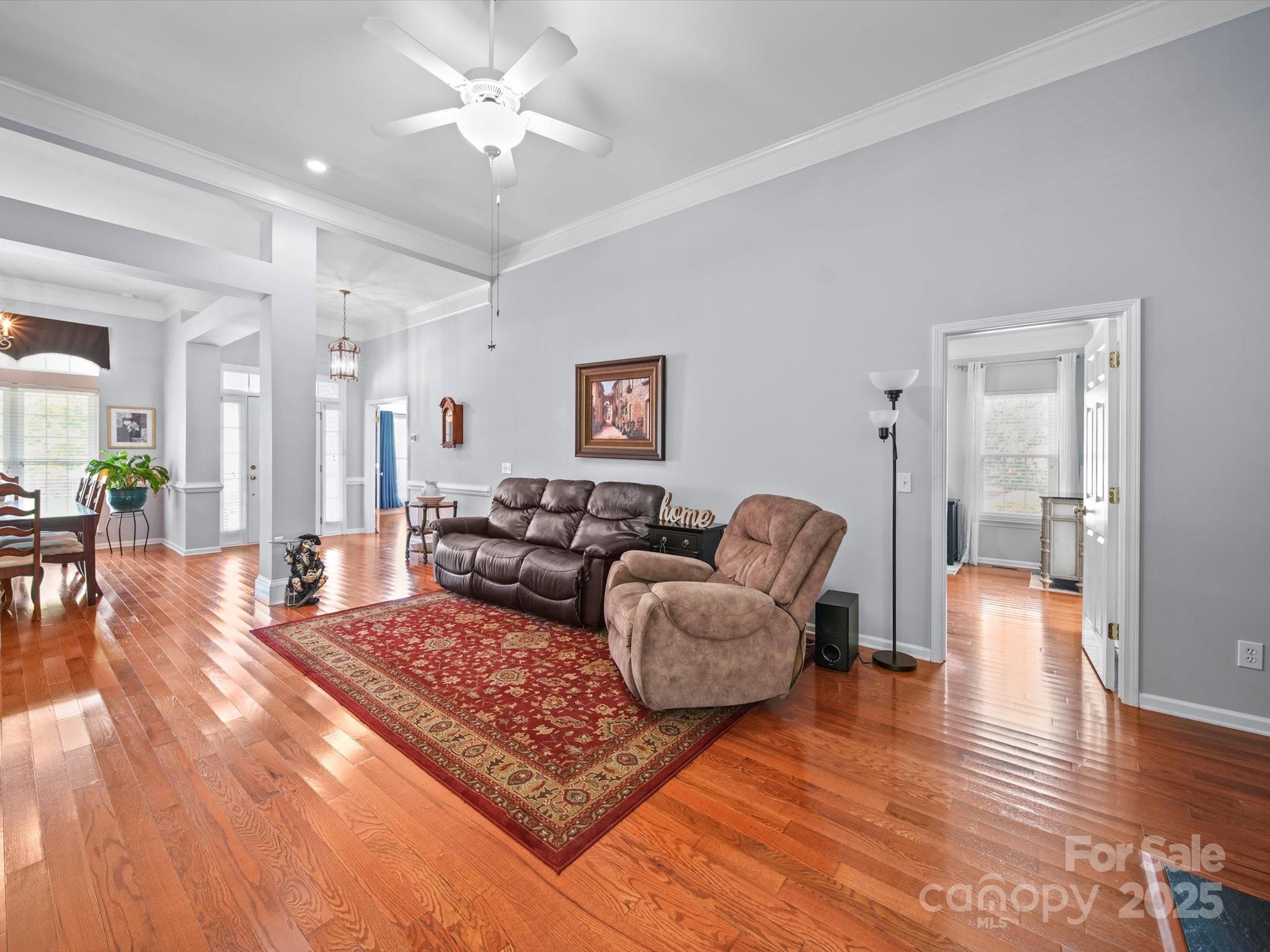 11761 Crossroads Place Concord, NC 28025 - Photo 5 of 32 a living room with furniture and a wooden floor