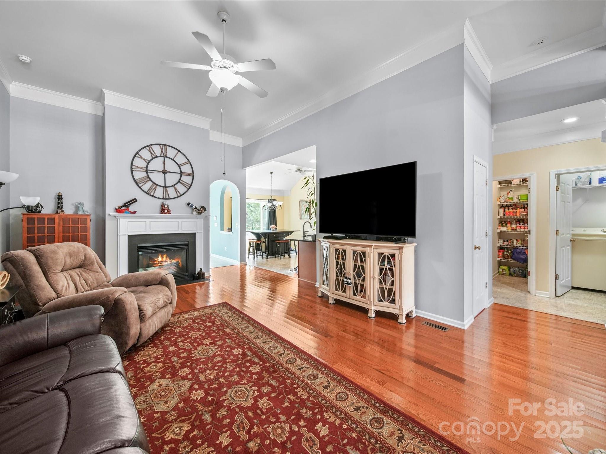 11761 Crossroads Place Concord, NC 28025 - Photo 9 of 32 a living room with furniture a flat screen tv and a fireplace