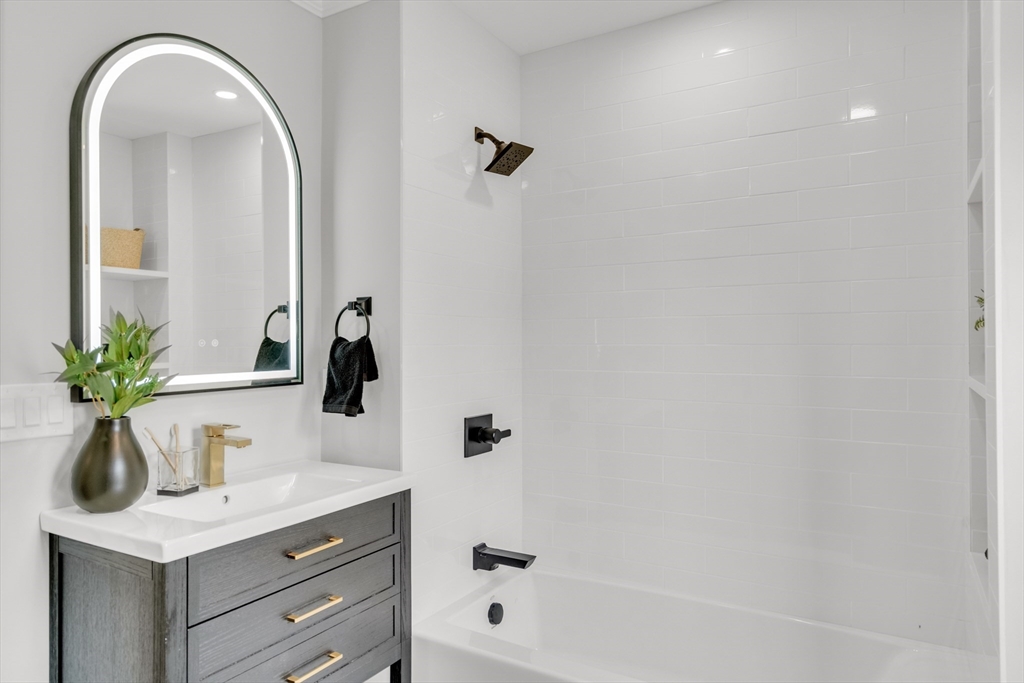 56 Pine Hill Road Dedham, MA 02026 - Photo 19 of 32 a bathroom with a sink a potted plant and a mirror