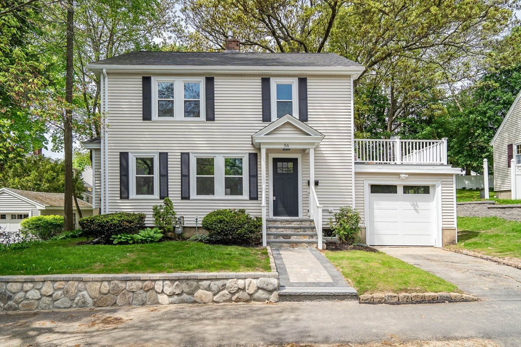 56 Pine Hill Road Dedham, MA 02026 - Photo 2 of 32 a front view of a house with a yard and a garage