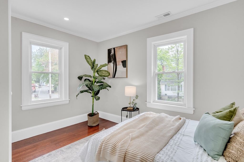 56 Pine Hill Road Dedham, MA 02026 - Photo 24 of 32 a bedroom with a bed potted plant and windows