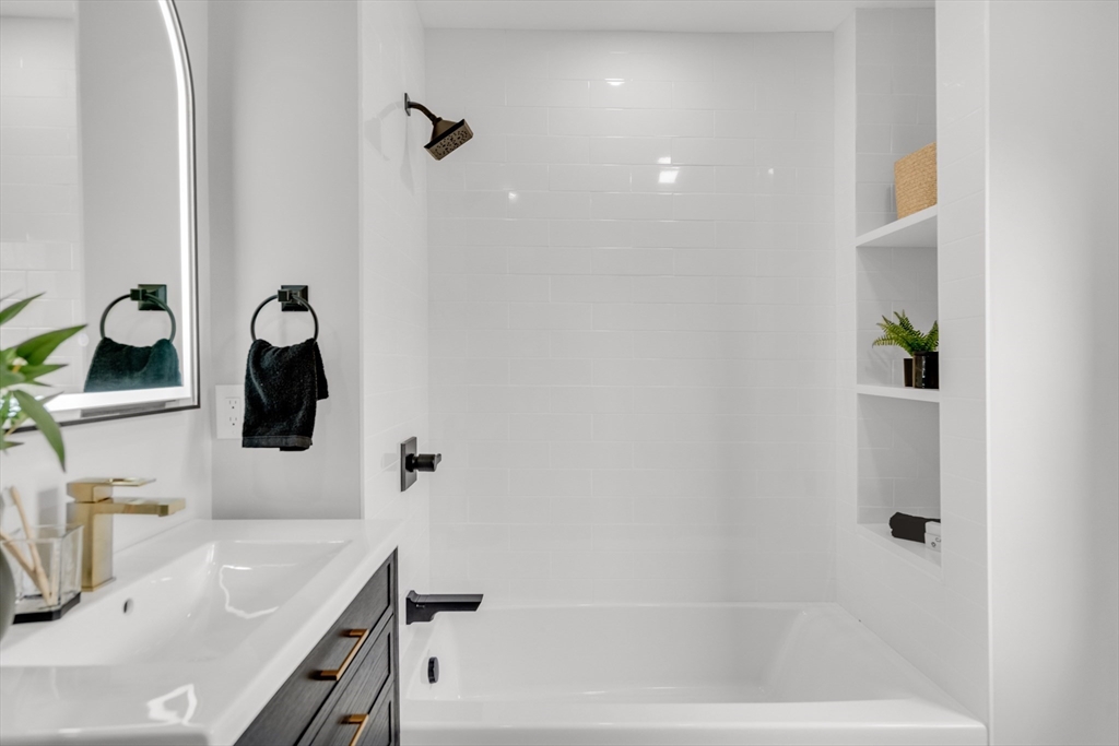 56 Pine Hill Road Dedham, MA 02026 - Photo 26 of 32 a bathroom with a tub sink and mirror