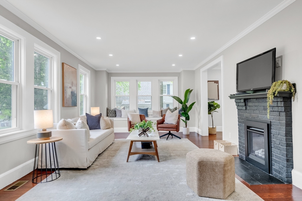 56 Pine Hill Road Dedham, MA 02026 - Photo 6 of 32 a living room with furniture a flat screen tv and a fireplace