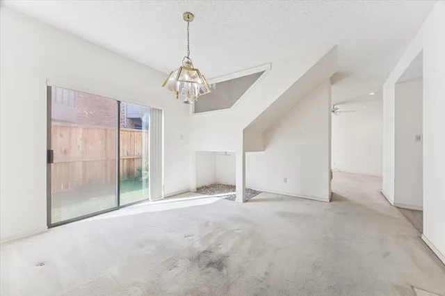 a view of empty room with wooden floor and ceiling fan