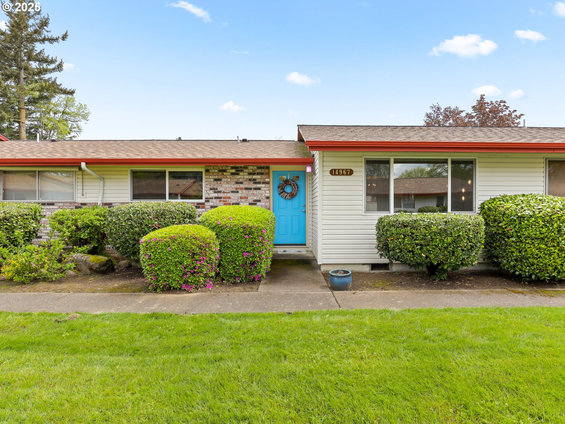 a view of a house with porch and garden