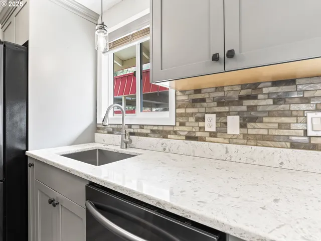 a stove top oven sitting inside of a kitchen