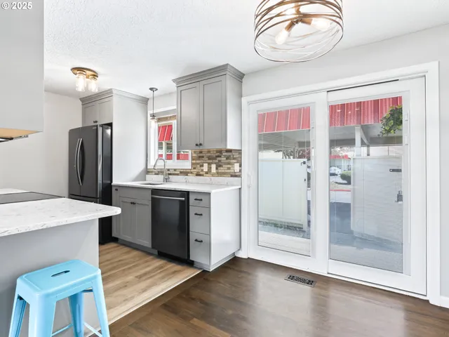 an empty room with wooden floor and window