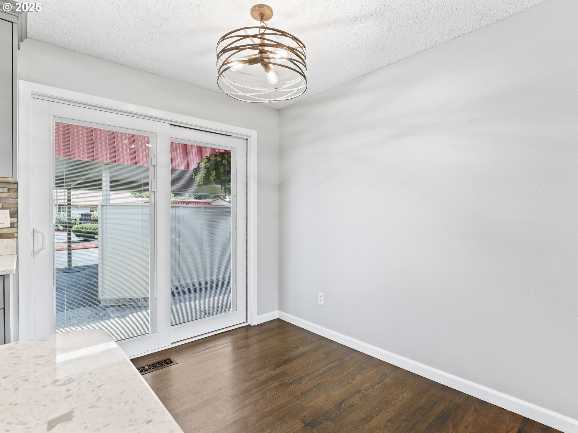 14967 Southeast Grant Court Portland, OR 97233 - Photo 17 of 46 an empty room with wooden floor and windows