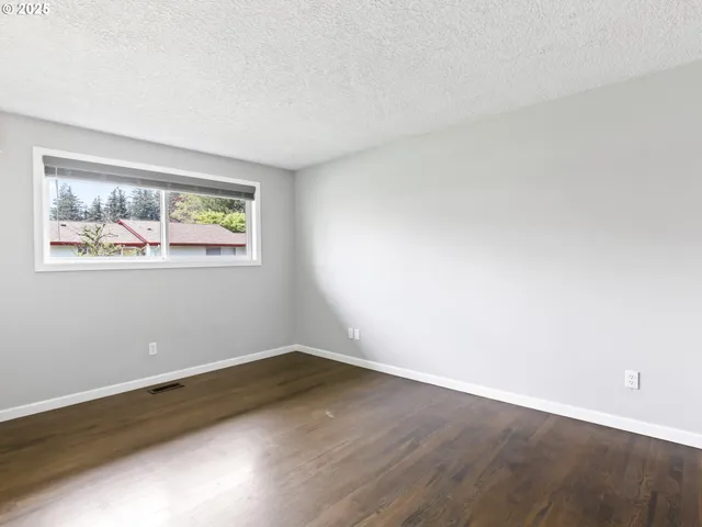 an empty room with wooden floor and closet